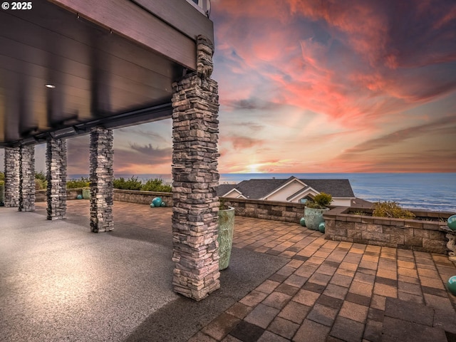 view of patio with a water view