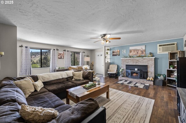 204 Adam Dr, Canyon City, OR 97820 - living room featuring a ceiling fan, a wall mounted AC, dark wood-style flooring, and a textured ceiling