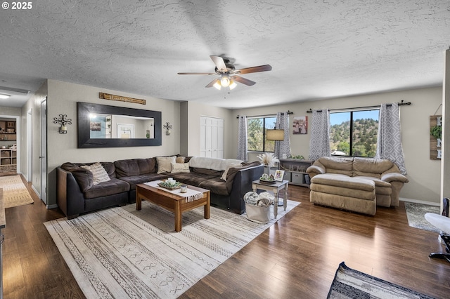204 Adam Dr, Canyon City, OR 97820 - living room featuring ceiling fan, a textured ceiling, dark wood-style floors, and baseboards