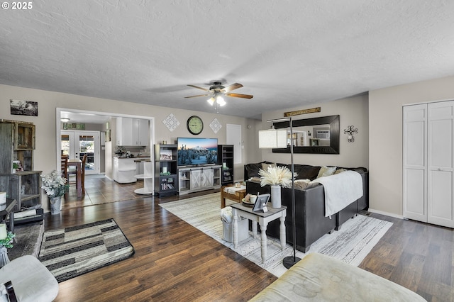 204 Adam Dr, Canyon City, OR 97820 - living area featuring dark wood-style flooring, ceiling fan, a textured ceiling, baseboards, and french doors
