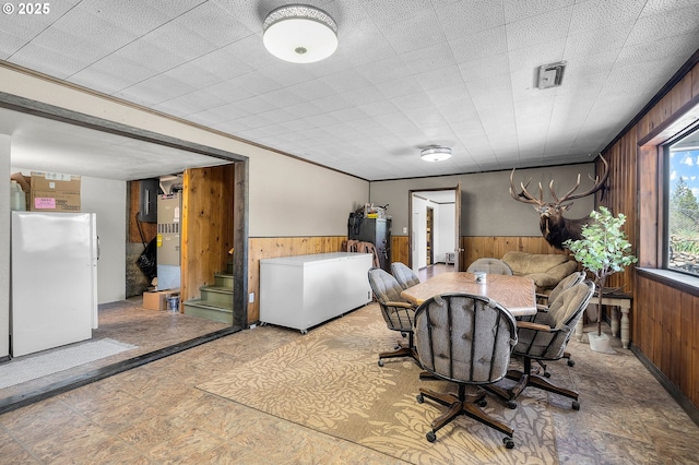 204 Adam Dr, Canyon City, OR 97820 - dining room with wood walls, a wainscoted wall, and stairs