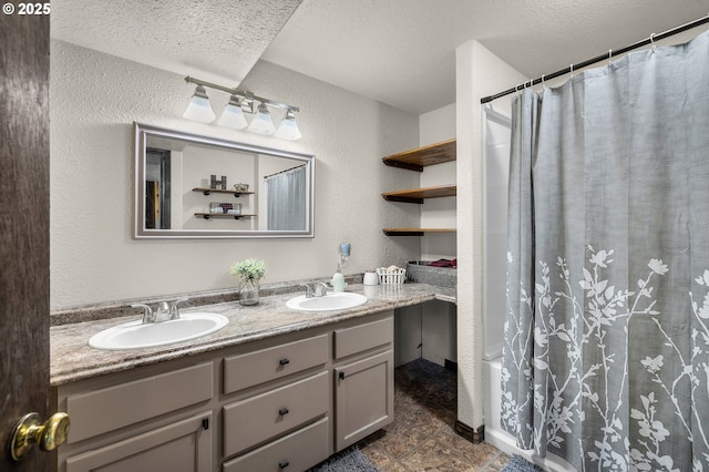 204 Adam Dr, Canyon City, OR 97820 - bathroom featuring double vanity, a textured wall, a textured ceiling, and shower / tub combo