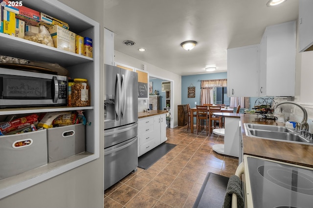 204 Adam Dr, Canyon City, OR 97820 - kitchen featuring stainless steel appliances, a sink, white cabinetry, butcher block counters, and recessed lighting