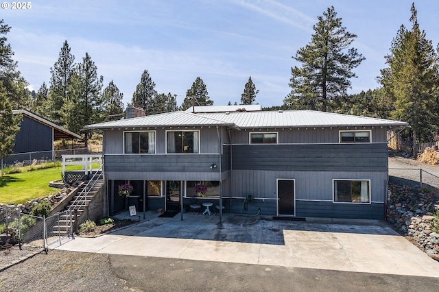 204 Adam Dr, Canyon City, OR 97820 - rear view of property with stairway, a patio area, fence, and metal roof