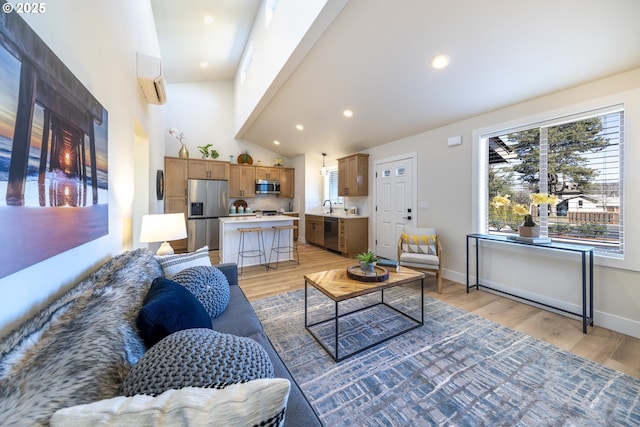 living room featuring recessed lighting, baseboards, a towering ceiling, and light wood finished floors