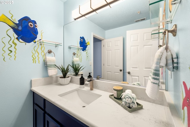 bathroom with vanity and visible vents