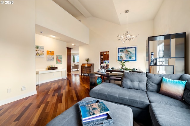 living room with a notable chandelier, wood finished floors, baseboards, and high vaulted ceiling