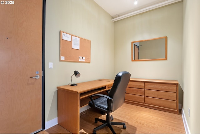 home office with baseboards and light wood finished floors