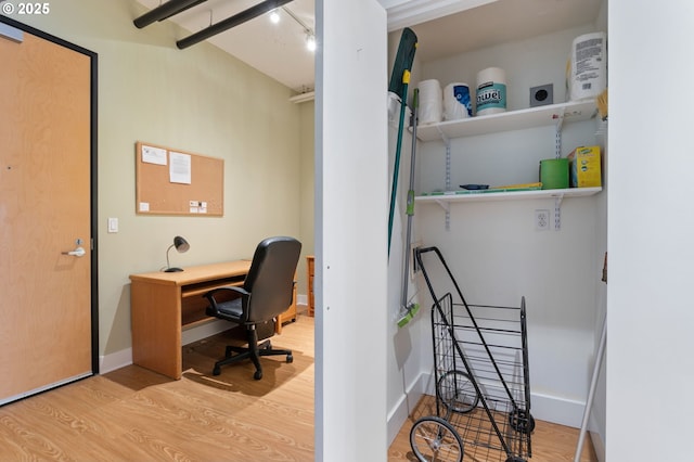 home office with baseboards and wood finished floors
