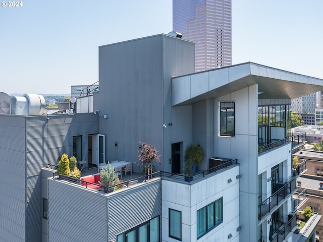 view of patio / terrace featuring a view of city and a balcony