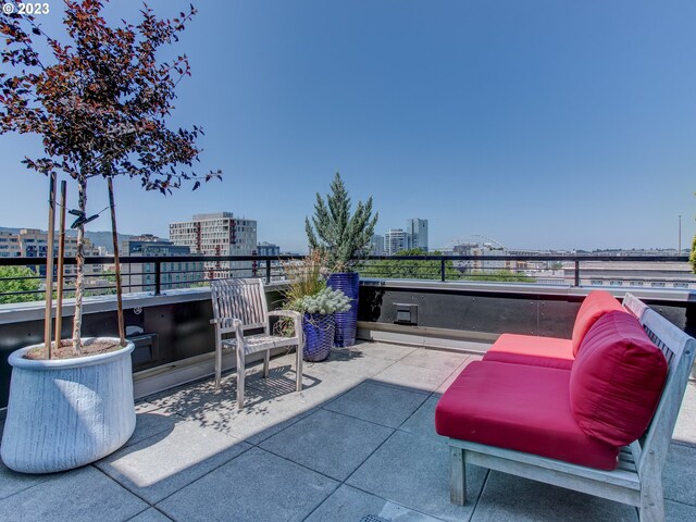 view of patio / terrace featuring a view of city and a balcony