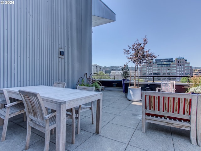 view of patio / terrace with a city view and outdoor dining space