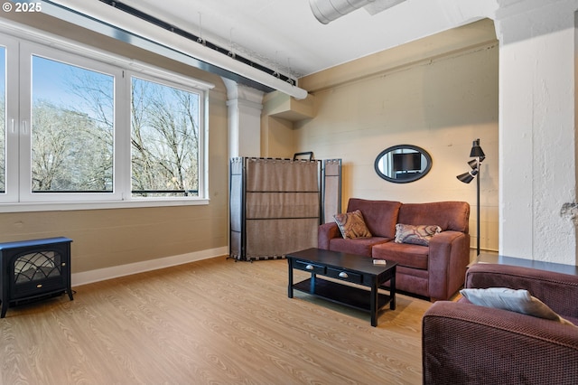 sitting room with baseboards and wood finished floors