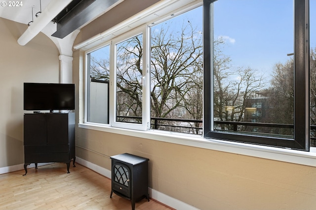 living area with baseboards and wood finished floors