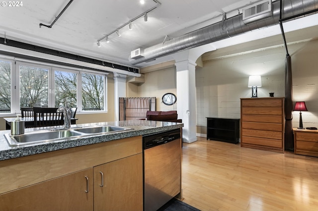 kitchen with rail lighting, sink, decorative columns, dishwasher, and light hardwood / wood-style floors