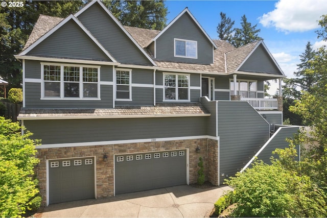 view of front of property with stone siding, a garage, and concrete driveway