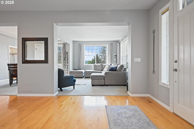 foyer featuring wood finished floors and baseboards