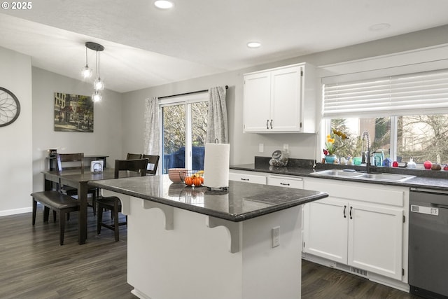 kitchen featuring sink, decorative light fixtures, stainless steel dishwasher, and white cabinets