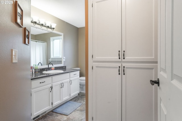 bathroom featuring vanity and toilet