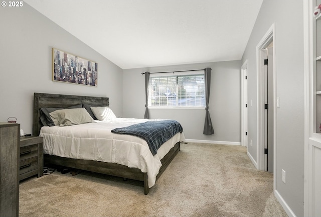 carpeted bedroom featuring lofted ceiling