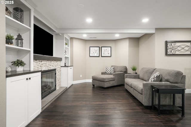 living room with dark wood-type flooring and built in shelves