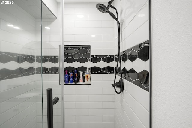 bathroom with tiled shower