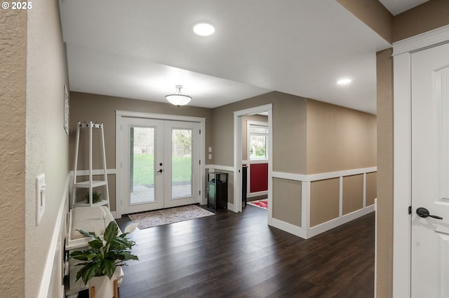 foyer featuring dark wood-type flooring and french doors