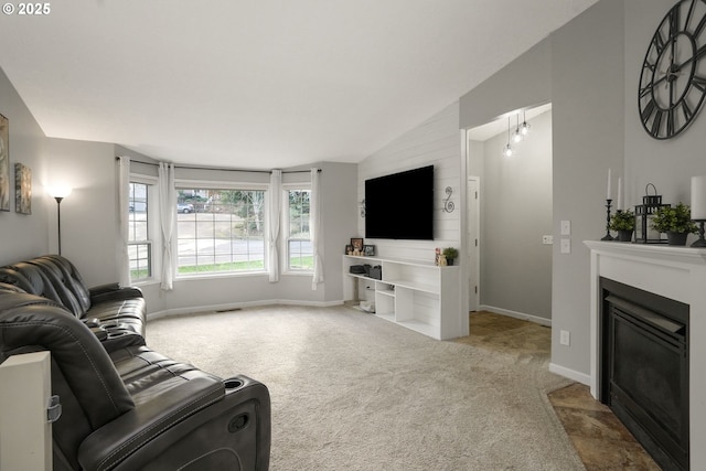 carpeted living room with lofted ceiling