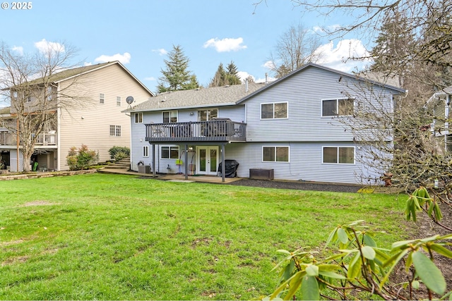 rear view of property with central AC unit, a yard, and a deck