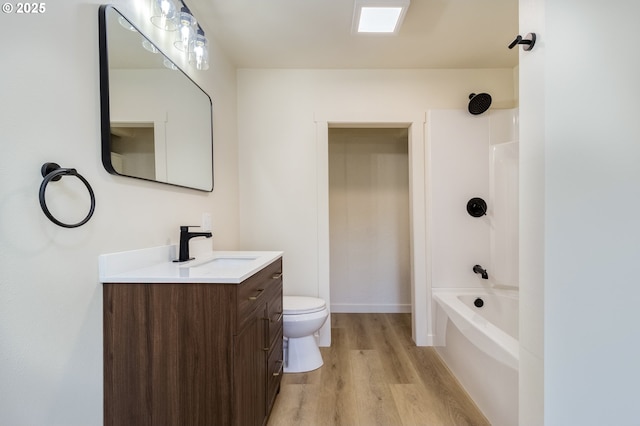 full bathroom featuring vanity, shower / washtub combination, hardwood / wood-style floors, and toilet