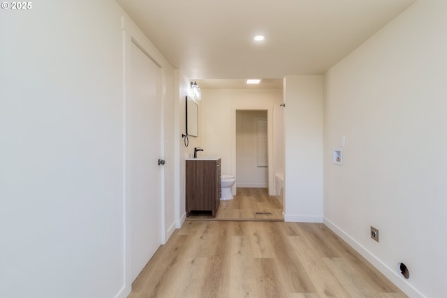 hall featuring sink and light hardwood / wood-style flooring