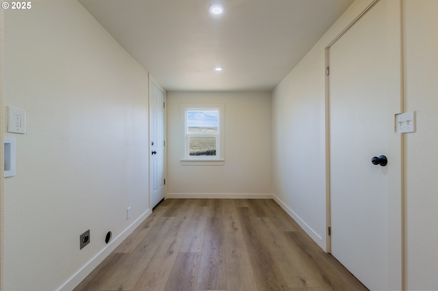 interior space with electric dryer hookup and light wood-type flooring