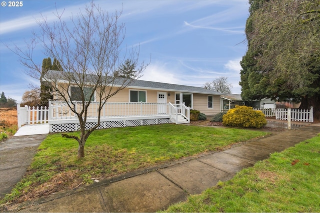 single story home featuring a front lawn and a deck