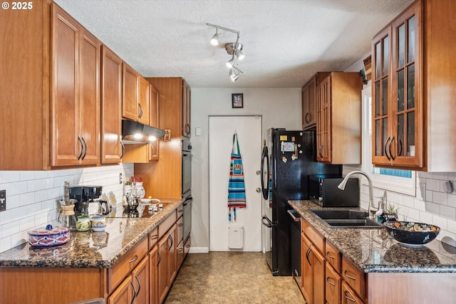 1903 SE 158th Ave, Portland, OR 97233 - kitchen featuring brown cabinets, glass insert cabinets, backsplash, a textured ceiling, and under cabinet range hood