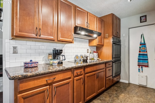 1903 SE 158th Ave, Portland, OR 97233 - kitchen with black appliances, under cabinet range hood, brown cabinets, decorative backsplash, and dark stone countertops