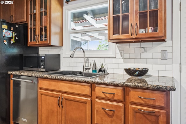 1903 SE 158th Ave, Portland, OR 97233 - kitchen with stainless steel microwave, backsplash, brown cabinets, glass insert cabinets, and dark stone countertops