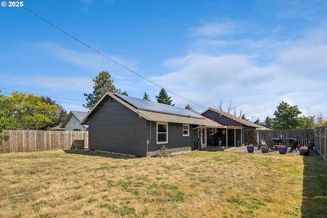 1903 SE 158th Ave, Portland, OR 97233 - rear view of house with a fenced backyard, roof mounted solar panels, and a patio
