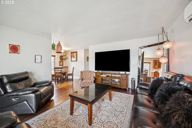 1903 SE 158th Ave, Portland, OR 97233 - living room featuring wood finished floors, a textured ceiling, and a wall mounted air conditioner