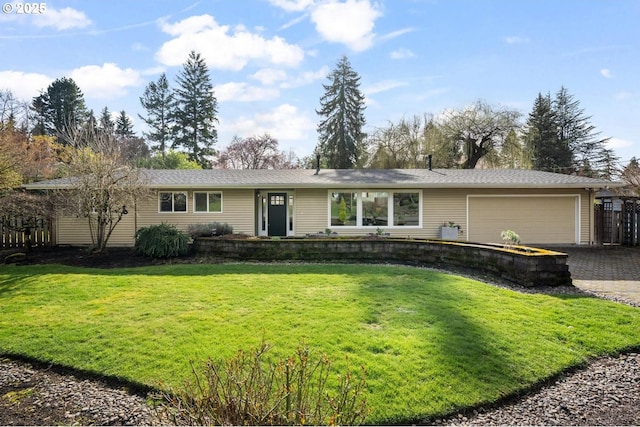 ranch-style home with a front lawn, driveway, and an attached garage