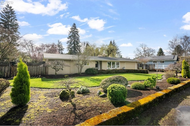 back of house with a yard, an attached garage, and fence