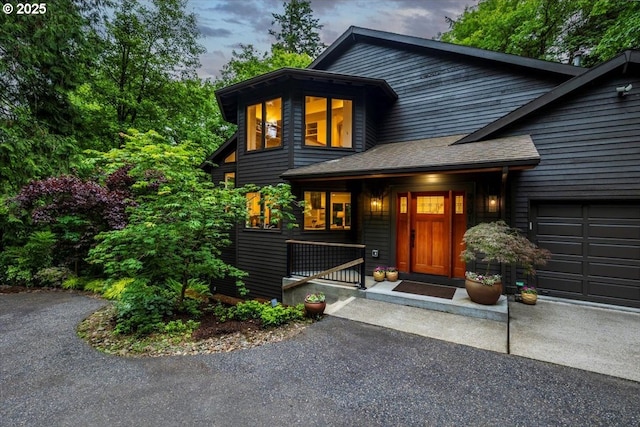 2010 S Palatine Hill Rd, Portland, OR 97219 - view of front of house featuring an attached garage, driveway, covered porch, and a shingled roof