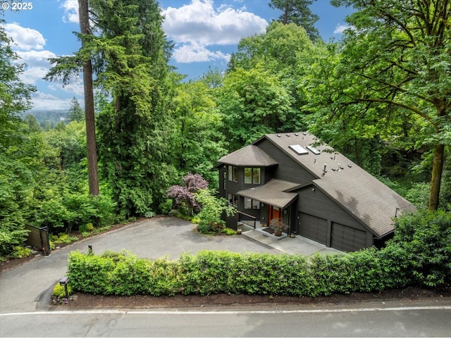 2010 S Palatine Hill Rd, Portland, OR 97219 - view of front facade featuring driveway, a wooded view, and roof with shingles