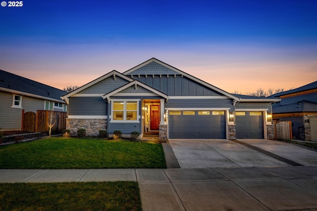 craftsman house with board and batten siding, concrete driveway, fence, and an attached garage