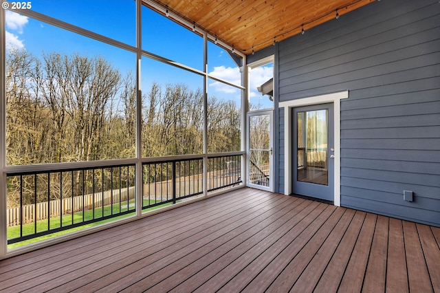 unfurnished sunroom with wooden ceiling