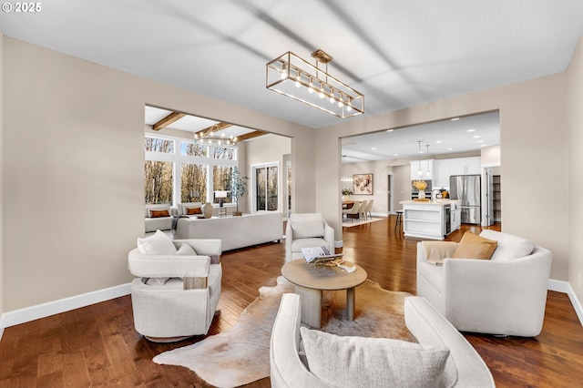 living room featuring baseboards, dark wood finished floors, beamed ceiling, and recessed lighting