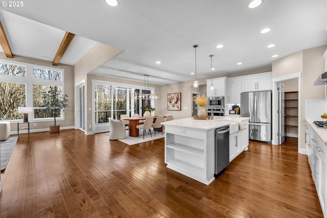 kitchen with dark wood finished floors, appliances with stainless steel finishes, light countertops, white cabinetry, and open shelves