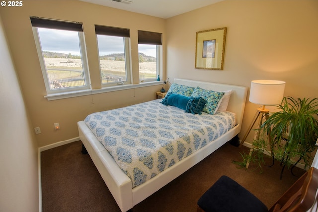 carpeted bedroom featuring baseboards and visible vents