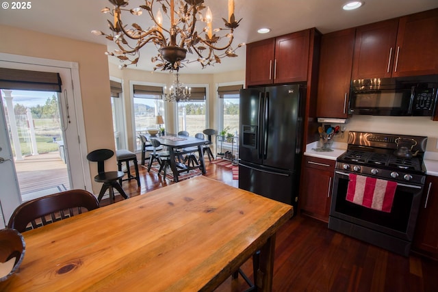 kitchen with black appliances, an inviting chandelier, decorative light fixtures, dark wood finished floors, and recessed lighting