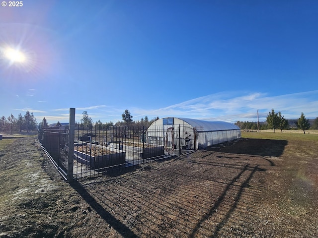 exterior space with fence, an outbuilding, and an exterior structure