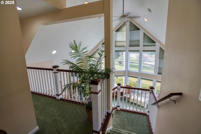 stairway with recessed lighting, a high ceiling, a ceiling fan, and carpet